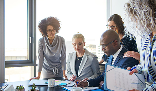 Group Of Focused Business People Working With Their Manager